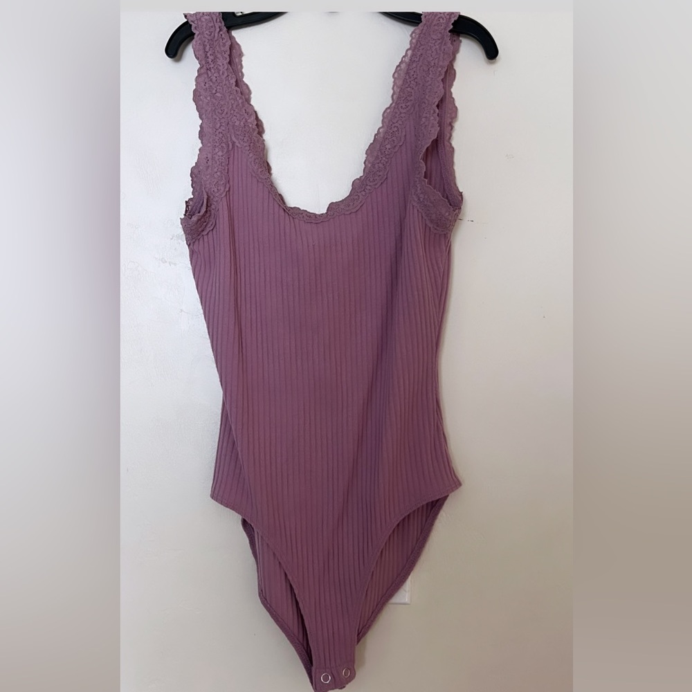 A purple very fitting body suit from forever 21.
